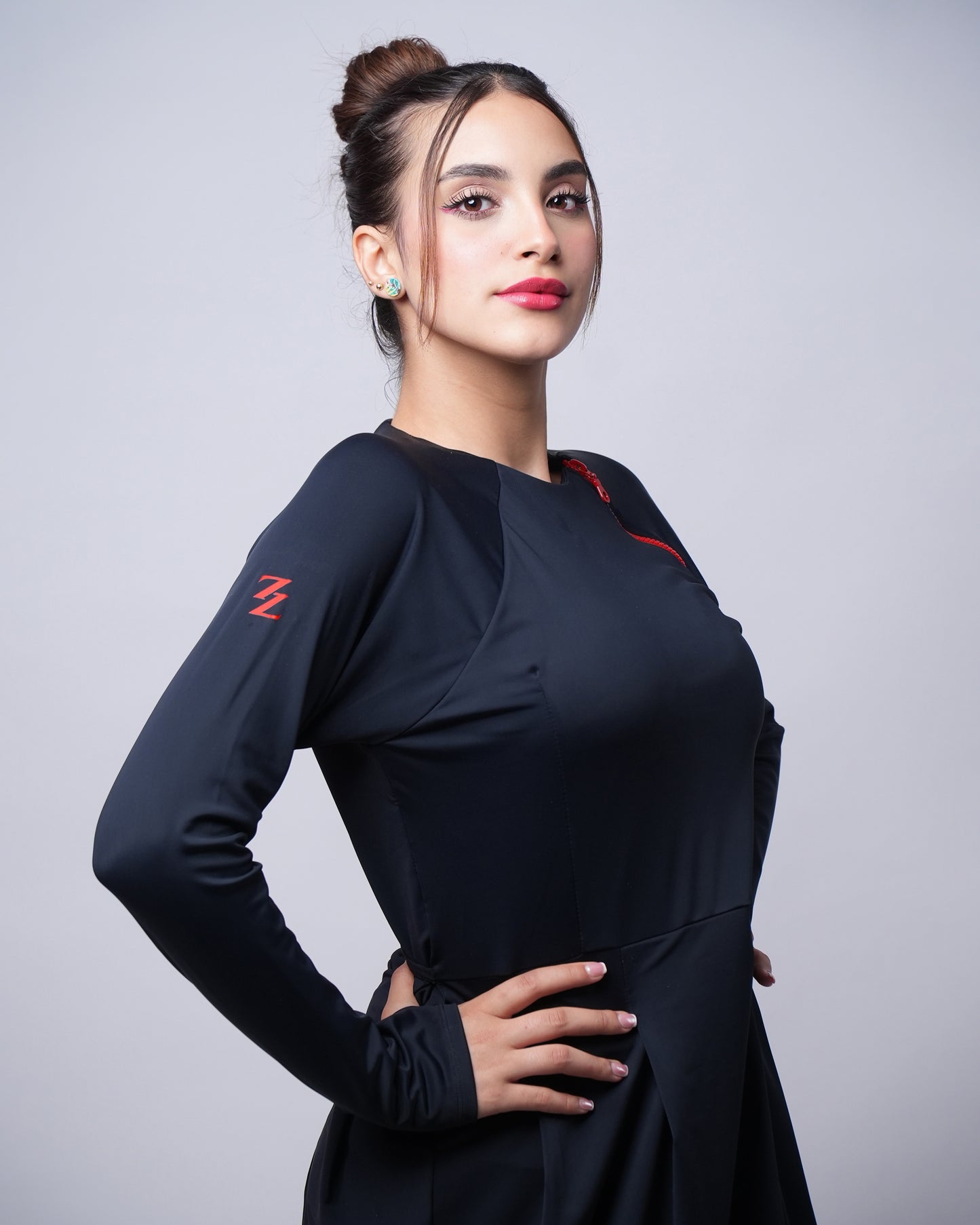 Tunique de bain sportive ModestSun pour femme, coupe longue et ample, tissu noir anti-UV avec logo rouge Z, idéale pour surf, natation et sports nautiques.
